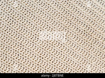 Hintergrund der handgefertigten gestrickten Stoff aus Baumwolle White Cream Farbe, Stoff gestrickt Textur. Stockfoto