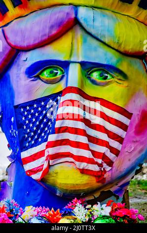 Ein Hausbesitzer macht eine politische Erklärung mit Mardi Gras Dekorationen mit der Freiheitsstatue, die eine amerikanische Flagge als Gesichtsmaske und Schnauze trägt. Stockfoto