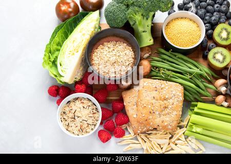 Lebensmittel mit hohem Ballaststoffanteil auf grauem Hintergrund. Gesundes Lebensmittelkonzept. Draufsicht, flach liegend, Kopierbereich Stockfoto