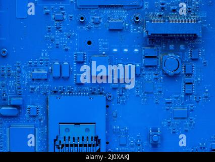 Hauptplatine des Computers. Klassischer blauer Hintergrund mit pc-Hintergrund, Nahaufnahme. Einfarbiger Mikrochip Stockfoto