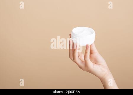 Nahaufnahme von Hand halten Cremeglas. Hochwertiges, schönes Fotokonzept Stockfoto