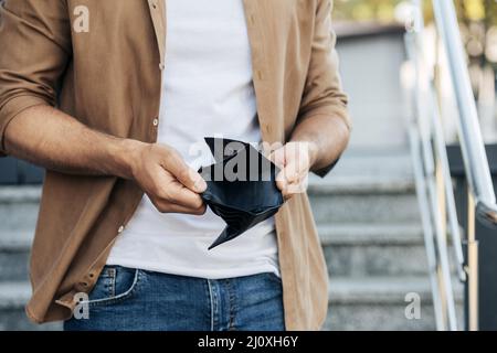 Nahaufnahme der Hände mit leerer Brieftasche. Hochwertiges, schönes Fotokonzept Stockfoto