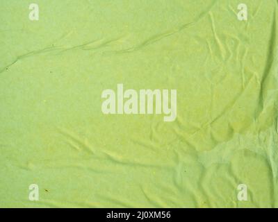 Nahaufnahme des grünen zerknitterte Papierhintergrunds. Hochwertiges, schönes Fotokonzept Stockfoto