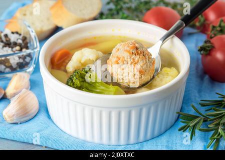 Leckere, dicke Suppe mit Putenfleischbällchen und gemischtem Gemüse - Blumenkohl, Brokkoli, Karotten, Kartoffeln, Knoblauch, Tomaten. C Stockfoto