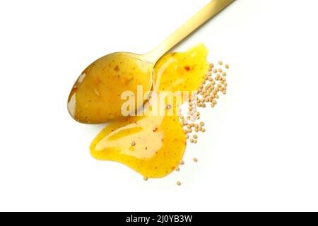 Löffel mit Senfhonig-Sauce isoliert auf weißem Hintergrund Stockfoto