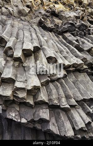 Felssäulen, die aus basaltischer Lava in Küstenklippen am Strand von Reynisfjara in der Nähe von Vik, Südküste Islands, entstanden sind. Stockfoto