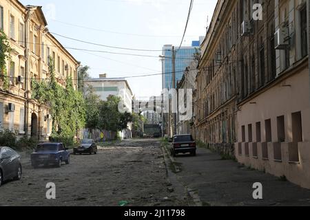 Straßenansicht der Devolanivskyi-Abfahrt (Spusk) in Odesa, Ukraine mit einer Brücke im Hintergrund; Autos werden auf der unbefestigten Straße mit alten Häusern geparkt Stockfoto