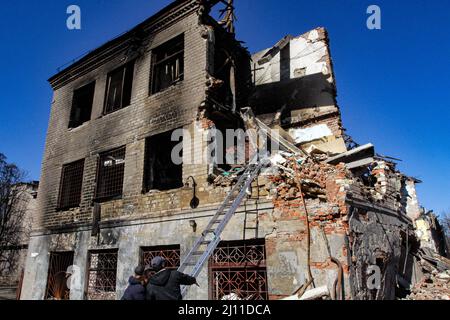 Dnipro, Ukraine - 21. März 2022 - zwei Männer legen eine Fleischleiter auf, um in das 2.. Stockwerk eines halb zerstörten Gebäudes zu gelangen, während die Folgen von Raketenangriffen im Stadtteil Nowokodatskyi der Stadt Dnipro, Ostukraine, beseitigt wurden.Foto: Mykola Myakshykov/Ukrinform/ABACAPRESS.COM Stockfoto