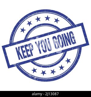 KEEP YOU GOING Text geschrieben auf blauen runden vintage Gummi Stempel. Stockfoto