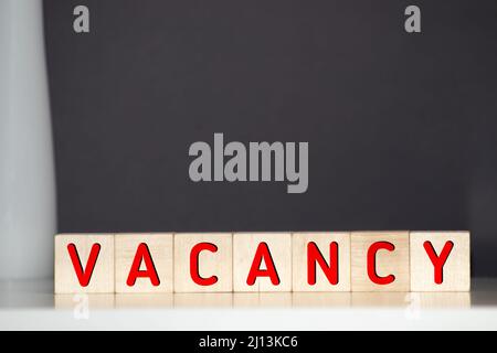 Leerstandswort auf Holzblock geschrieben. Vakanztext auf Holztisch für Ihr Design, Konzept Stockfoto