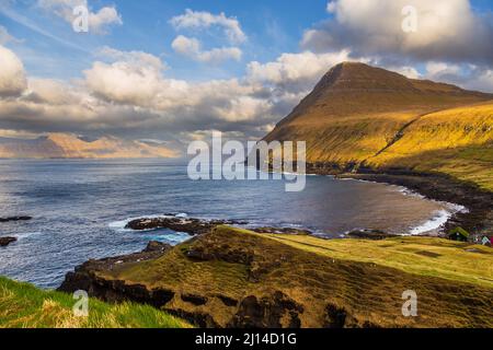 Das kleine Dorf Gjogv liegt am Hang des Berges auf der Insel Eysturoy. Schöne Bucht mit Strand.Färöer Inseln. Stockfoto