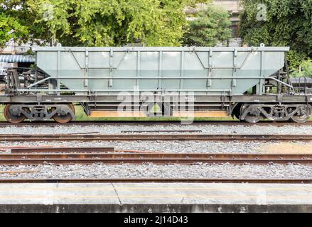 Der Fahrwerk-Trichterwagen wird in der Station geparkt, um darauf zu warten, dass die tragenden Steine bei der Eisenbahnwartung verwendet werden, Vorderansicht mit dem Kopierplatz. Stockfoto