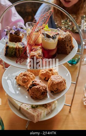 Vertikale Aufnahme von Tellern Kuchen und Kekse auf dem Tisch Stockfoto