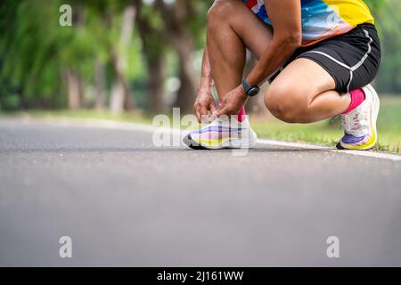 Nahaufnahme von Senior man beim Binden von Laufschuhen. Stockfoto