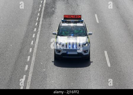 Ein Coruna-Spanien. Luftaufnahme eines Wagens des spanischen Verkehrsbeamten mit einem elektronischen Schild, das auf Vorsicht hinweist, am 23. März 2022 Stockfoto