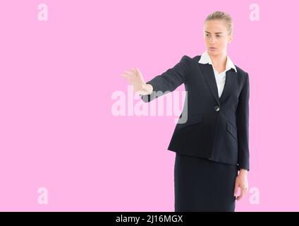 Kaukasische Geschäftsfrau hält ein unsichtbares Objekt gegen den Kopierraum auf rosa Hintergrund Stockfoto