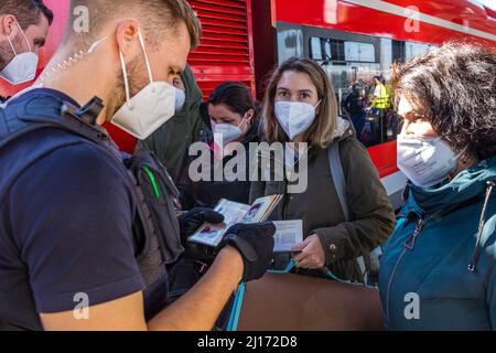 Cottbus, Deutschland. 23. März 2022. Flüchtlinge aus der Ukraine zeigen ihre Dokumente Beamten der Bundespolizei. Nach Hannover und Berlin soll Cottbus die dritte Drehscheibe für die Verteilung von Flüchtlingen aus der Ukraine werden. Ab Mittwoch sollen täglich sechs Sonderzüge mit insgesamt bis zu 3.600 Personen eintreffen. Quelle: Frank Hammerschmidt/dpa-Zentralbild/dpa/Alamy Live News Stockfoto