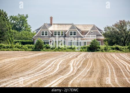 Landschaft bestehend aus einem frisch gepflügten Feld und einem teuren Zuhause Stockfoto