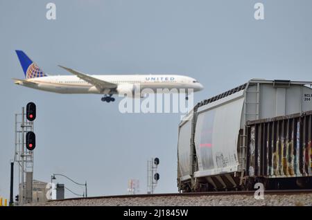 BENSENVILLE, Illinois, USA. Ein Düsenflugzeug schwebt über einem Güterzug, während es am O'Hare International Airport in Chicago landet. Stockfoto