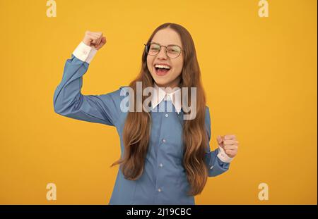 Bildung ist der Schlüssel zum Erfolg. Glücklich Tween Mädchen zeigen siegreiche Geste. Erfolg wird gefeiert. Stockfoto