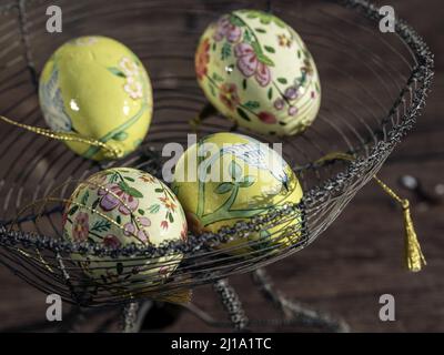 Eine Nahaufnahme der Ostereier in verschiedenen bunten Designs im Korb Stockfoto
