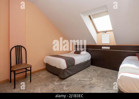 Einfaches Hotelzimmer im Dachgeschoss Stockfoto