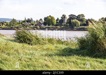 Blick über den Fluss Severn auf die St. Peters Church im Dorf Upper Framilode aus Rodley, Gloucestershire, England Stockfoto