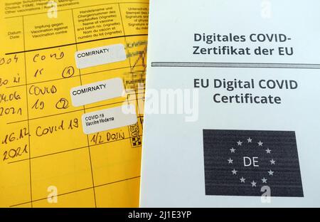 16.12.2021, Deutschland, , Berlin - Corona Impfprotokolle in einem Impfpass und einem digitalen Impfpass. 00S211216D629CAROEX.JPG [MOD Stockfoto