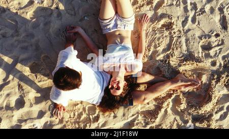 Ein Foto von einem Paar, das am Strand liegt Stockfoto