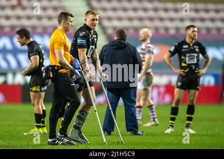 Wigan, Großbritannien. 25. März 2022. James Greenwood #12 von Salford Red Devils verlässt das Spielfeld auf Krücken, nachdem er während des Spiels in Wigan, Großbritannien, am 3/25/2022 eine Verletzung aufnahm. (Foto von Simon Whitehead/News Images/Sipa USA) Quelle: SIPA USA/Alamy Live News Stockfoto