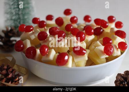 Ananas mit Käsekirsche. Eine leicht zu montierende, kochende Vorspeise. Aufgenommen auf weißem Hintergrund Stockfoto