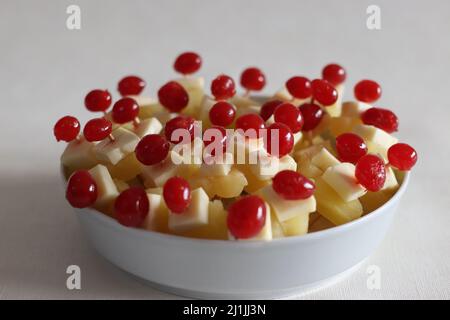 Ananas mit Käsekirsche. Eine leicht zu montierende, kochende Vorspeise. Aufgenommen auf weißem Hintergrund Stockfoto