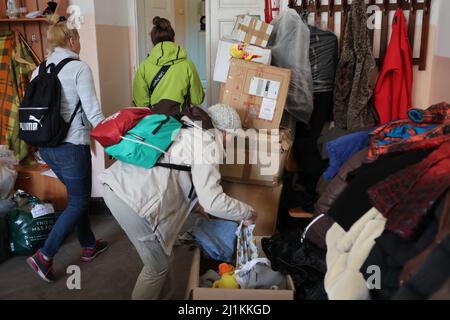 IVANO-FRANKIVSK, UKRAINE - 24. MÄRZ 2022 - Menschen besuchen ein Zentrum, das Binnenvertriebenen, die aus dem h geflohen sind, humanitäre Hilfe bietet Stockfoto