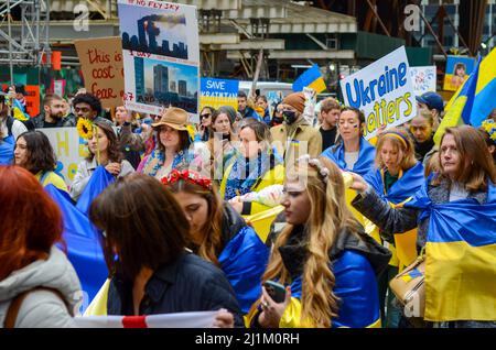 Demonstranten, die blau und gelb (ukrainische Flagge) trugen, um Solidarität mit der Ukraine zu zeigen, während die Mütter auf dem platz der Vereinten Nationen marschieren und m Stockfoto
