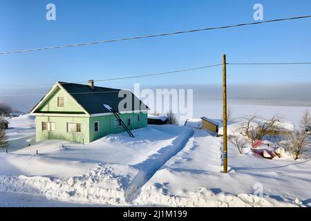 Schnee driftet vor dem grünen Holz ländlichen Haus im Winter Russland, Republik Karelien. Stockfoto
