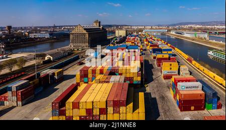 Industriehafen mit Containern in der Donau. Viele Waren warten auf den Versand im Hafen. Stockfoto