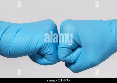 Zwei medizinische Mitarbeiter machen eine Fauststoß-Geste. Stockfoto