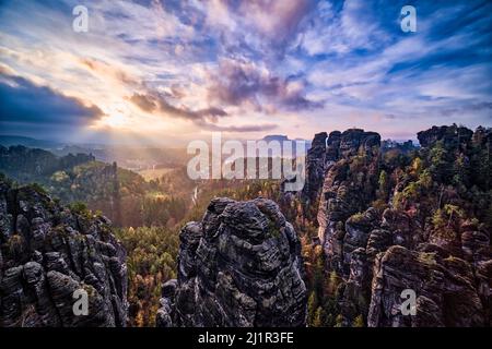 Landschaft mit Felsformationen, die Gipfel Hintere Gans und Höllenhund im Rathen-Gebiet des Nationalparks Sächsische Schweiz bei Sonnenaufgang im Herbst. Stockfoto