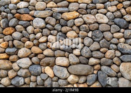 Gestapelte Steine als dekoratives Objekt im Hof. Hintergrundstruktur oder Musterkonzept. Stockfoto
