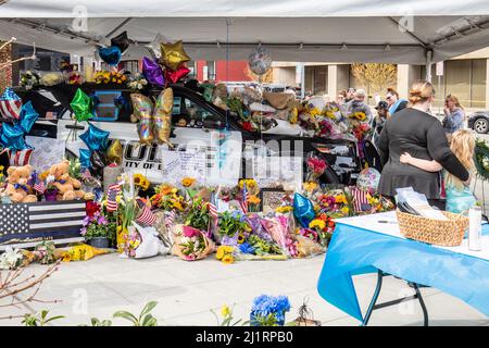 Everett, WA - USA: O3-27-2022:Blumen, Teddybären und Liebesbotschaften überschwappen in Everett einen Streifenwagen. Ein Denkmal für den gefallenen Offizier Dan Rocha On Stockfoto