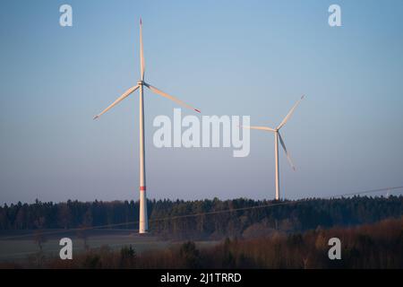 28. März 2022, Bayern, Büchlein: Windturbinen werden von Morgensonne beleuchtet. Der Krieg in der Ukraine beschleunigt die Debatte in Deutschland über den Ausbau erneuerbarer Energien. Foto: Nicolas Armer/dpa Stockfoto