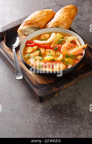 Caldeirada Portugiesische Meeresfrüchte Eintopf mit Garnelen, Muscheln und Tintenfisch in der Schüssel auf dem Tisch. Vertikal Stockfoto