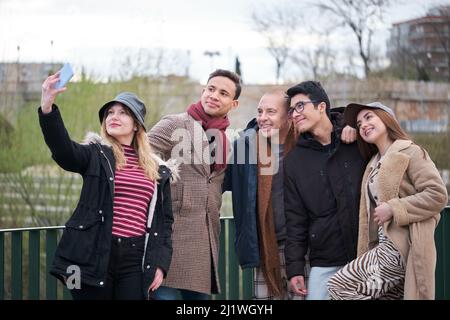 Eine Gruppe von Freunden unterschiedlichen Alters und Ethnien, die ein Selfie im Freien machen. Stockfoto