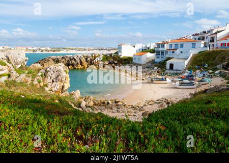 Schöner Fischerbach mit den Fischerbooten auf dem Sand und Baleal Strand im Hintergrund in Peniche Stockfoto