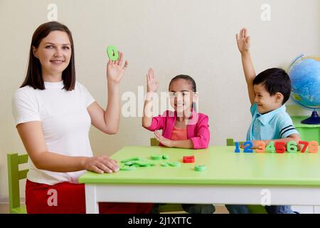 Kinder üben die korrekte Aussprache mit einem Logopädin Stockfoto