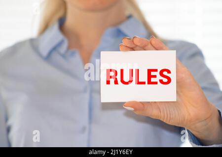 REGELN Wort auf der Karte von einer Frau gezeigt, vintage Ton. Stockfoto