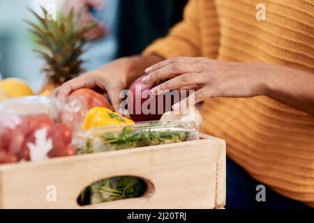 Eine gute Gesundheit ist sinnvoll. Eine kurze Aufnahme einer Frau, die ihre Lebensmittel in der Küche zu Hause auspackte. Stockfoto