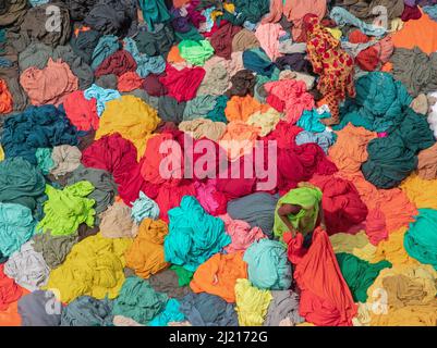 Narayanganj, Dhaka, Bangladesch. 29. März 2022. In Narayanganj, Bangladesch, sortieren Arbeiter bunte Stoffstapel, die zu Kleidungsstücken verarbeitet werden. Die Arbeiter sortieren und wählen die Stoffe nach Farbe, Qualität und der Nachfrage der Käufer aus. Die Stoffe werden in der Regel bei der Herstellung von Bekleidung verwendet. Sie werden für die Sortierung und Sortierung sowie zum Trocknen in der Sonne aufgeschichtet, wobei Feuchtigkeit aus dem Sterbeprozess entfernt wird. (Bild: © Joy Saha/ZUMA Press Wire) Stockfoto