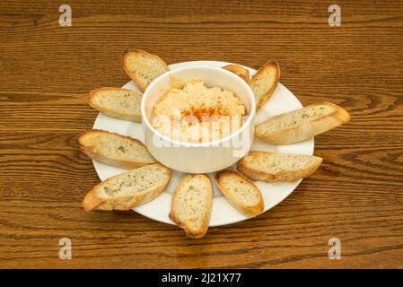 Kichererbsen-Hummus mit Paprika und Olivenöl mit gerösteten Brotscheiben Stockfoto