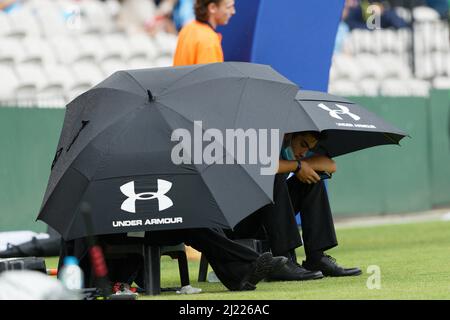 Sicherheitskräfte schützen sich vor dem Regen vor dem Beginn des Spiels am 27. März 2022 im Netstrata Jubilee Stadium in Sydney, Australien Stockfoto